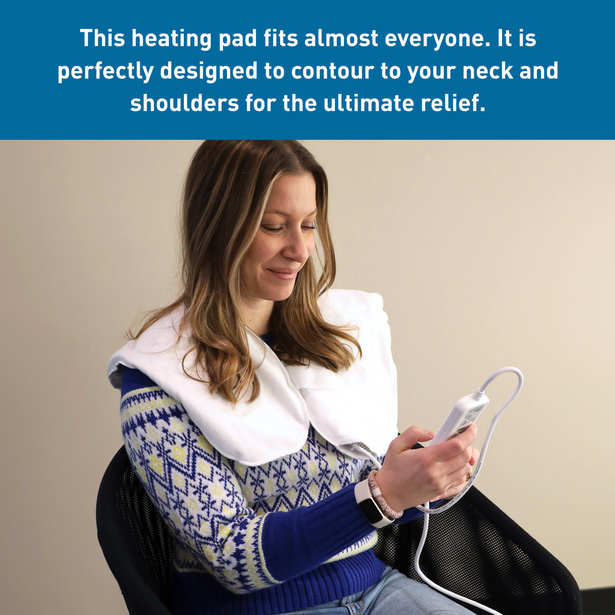 A woman sits smiling in a chair, using the BodyMed Digital Moist Heating Pad on her neck and shoulders for relief from muscle strains. She holds the control device and wears a blue patterned sweater. Text above highlights soothing moist heat therapy.