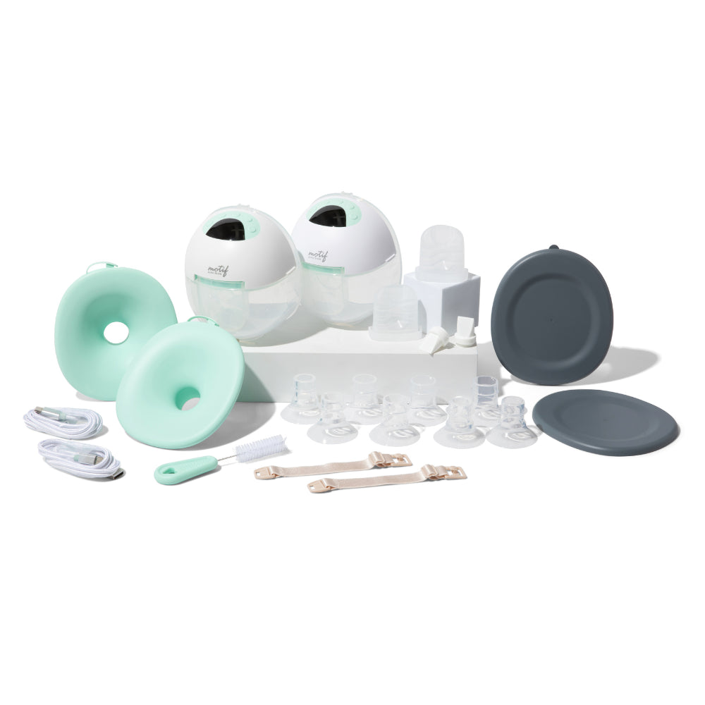 The Motif Aura Glow Wearable Breast Pump by Motif features two mint green and white pump units with silicone flanges, charging cables, bottle brushes, milk collection bottles, lids, and accessories arranged on a white surface.