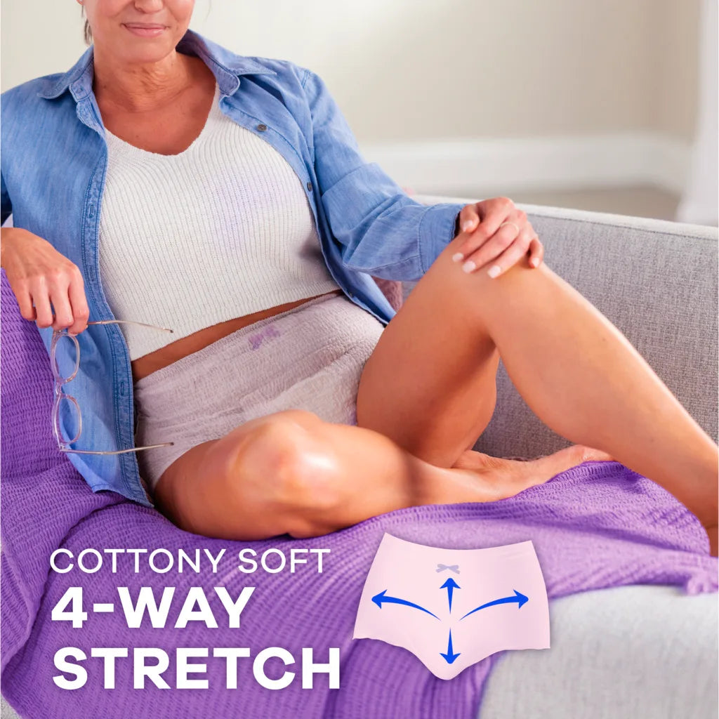 A woman in a light blue shirt and white top sits on a gray couch with a purple blanket, wearing Always Discreet Maximum Protection Underwear for Women. Text reads COTTONY SOFT 4-WAY STRETCH beside an icon with stretch arrows.