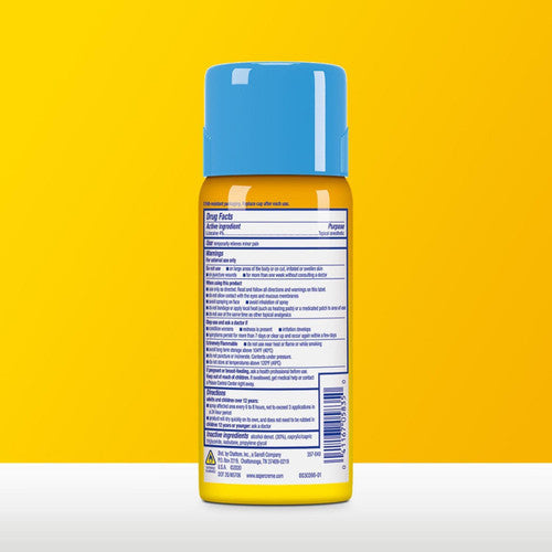 A yellow Aspercreme Max Strength Lidocaine Pain Relief Dry Spray 4 oz bottle with a blue cap stands upright against a bright yellow background. The back label shows drug facts and instructions for this odor free spray from Aspercreme.