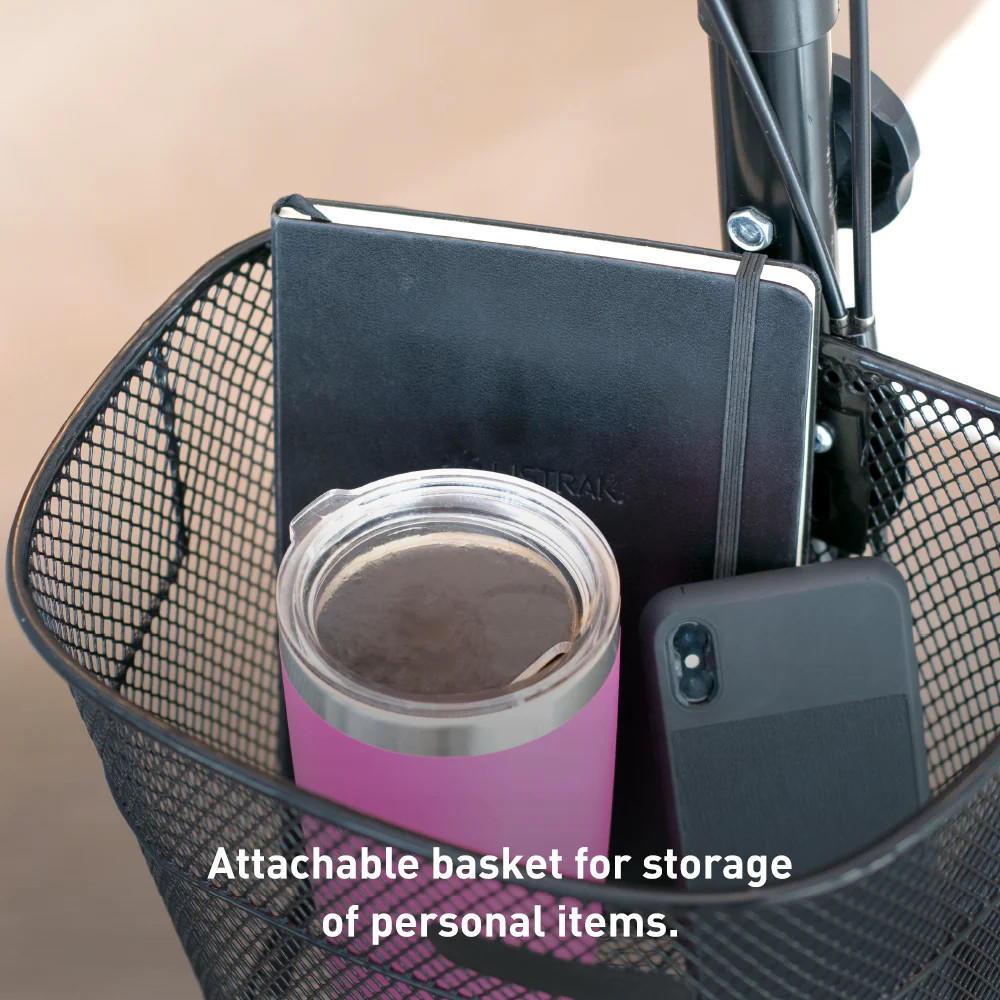 A black mesh basket on the BodyMed All-Terrain Knee Walker holds a closed notebook, pink travel mug with metal lid, and black smartphone. White text reads: Attachable basket for storage of personal items. Brand: BodyMed.