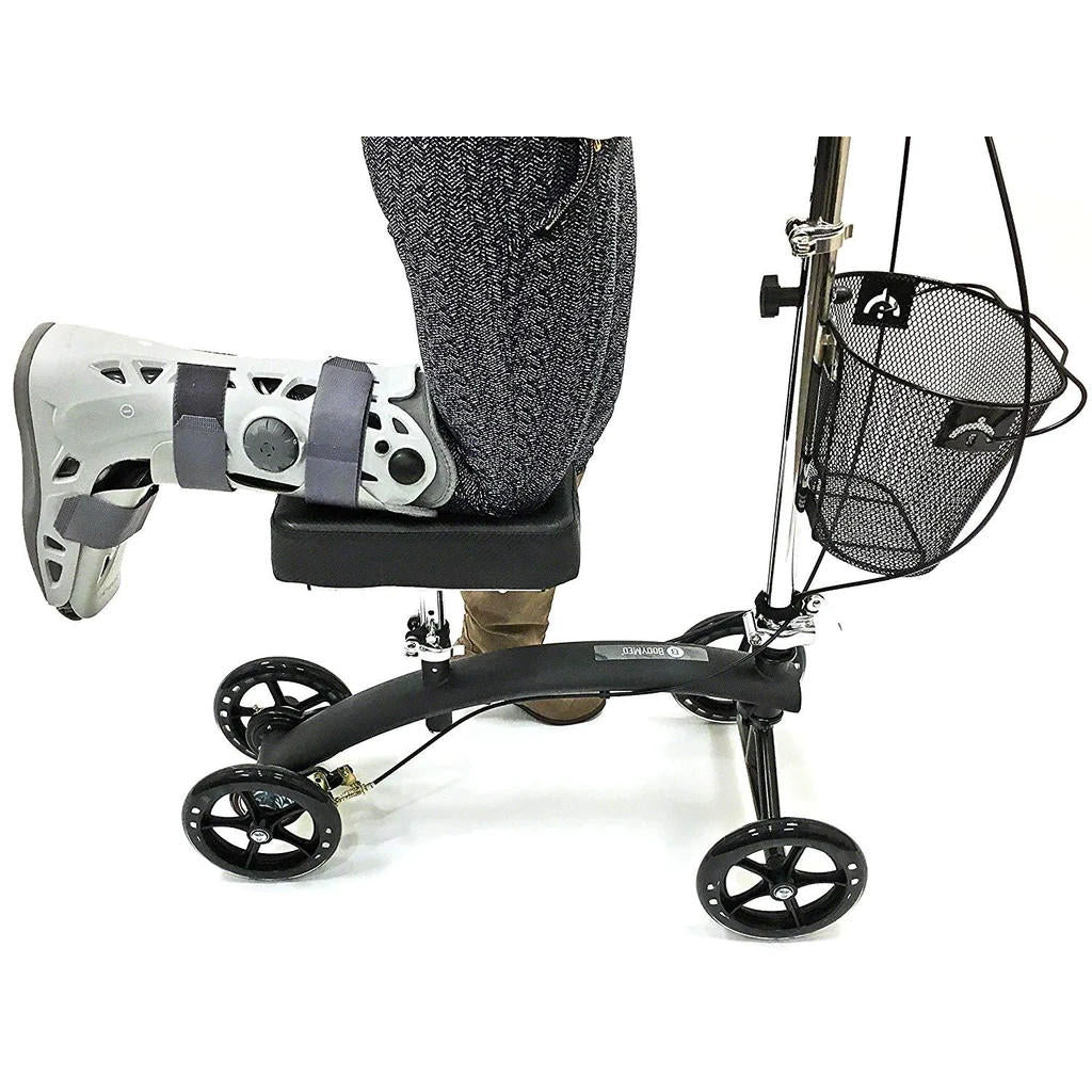A person with an injured leg rests it on the BodyMed Premium Knee Walker by BodyMed, a helpful mobility aid featuring four wheels and a mesh front basket.