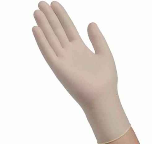 A left hand wears a Cardinal Health Positive Touch Exam Glove—light-colored, powder-free latex—with fingers extended and palm facing forward.