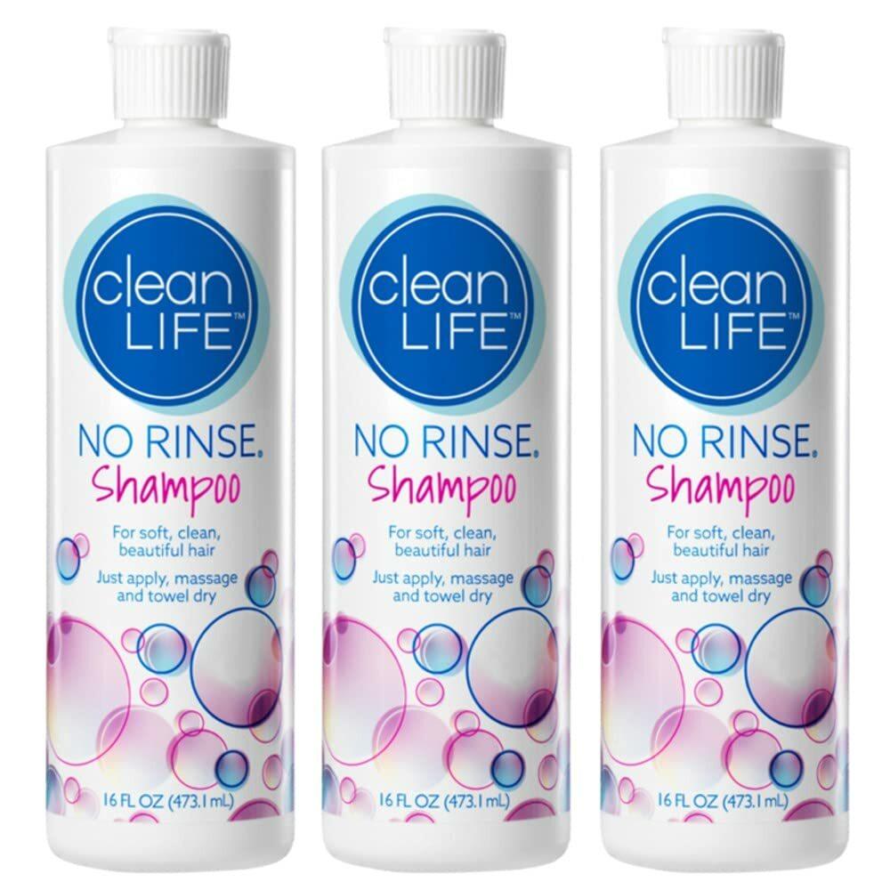 Three 16 oz bottles of CleanLife No Rinse Shampoo, featuring white caps and labels with blue and pink text, bubbles, and pH balanced instructions.