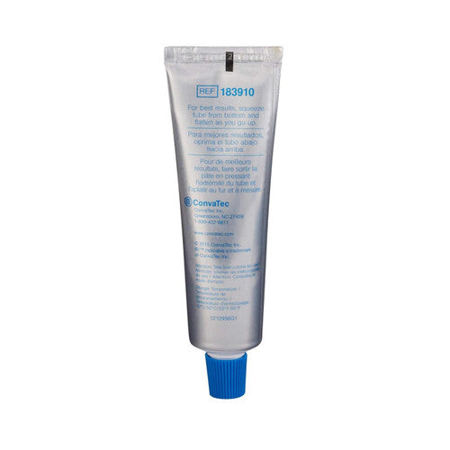 A silver tube with a blue cap labeled “ConvaTec Stomahesive Protective Skin Barrier Paste, 2 oz” features usage instructions and product details in multiple languages.