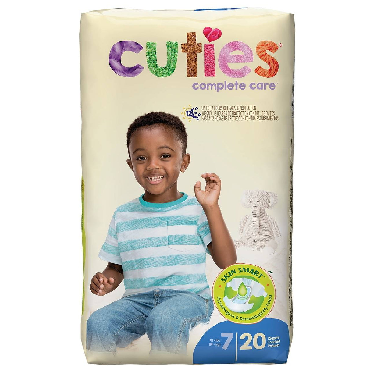 A pack of First Quality Cuties Complete Care Baby Diapers, Size 7, features a smiling boy in a striped shirt holding up three fingers with a white stuffed animal behind him. The pack provides reliable leakage protection and contains 20 diapers.