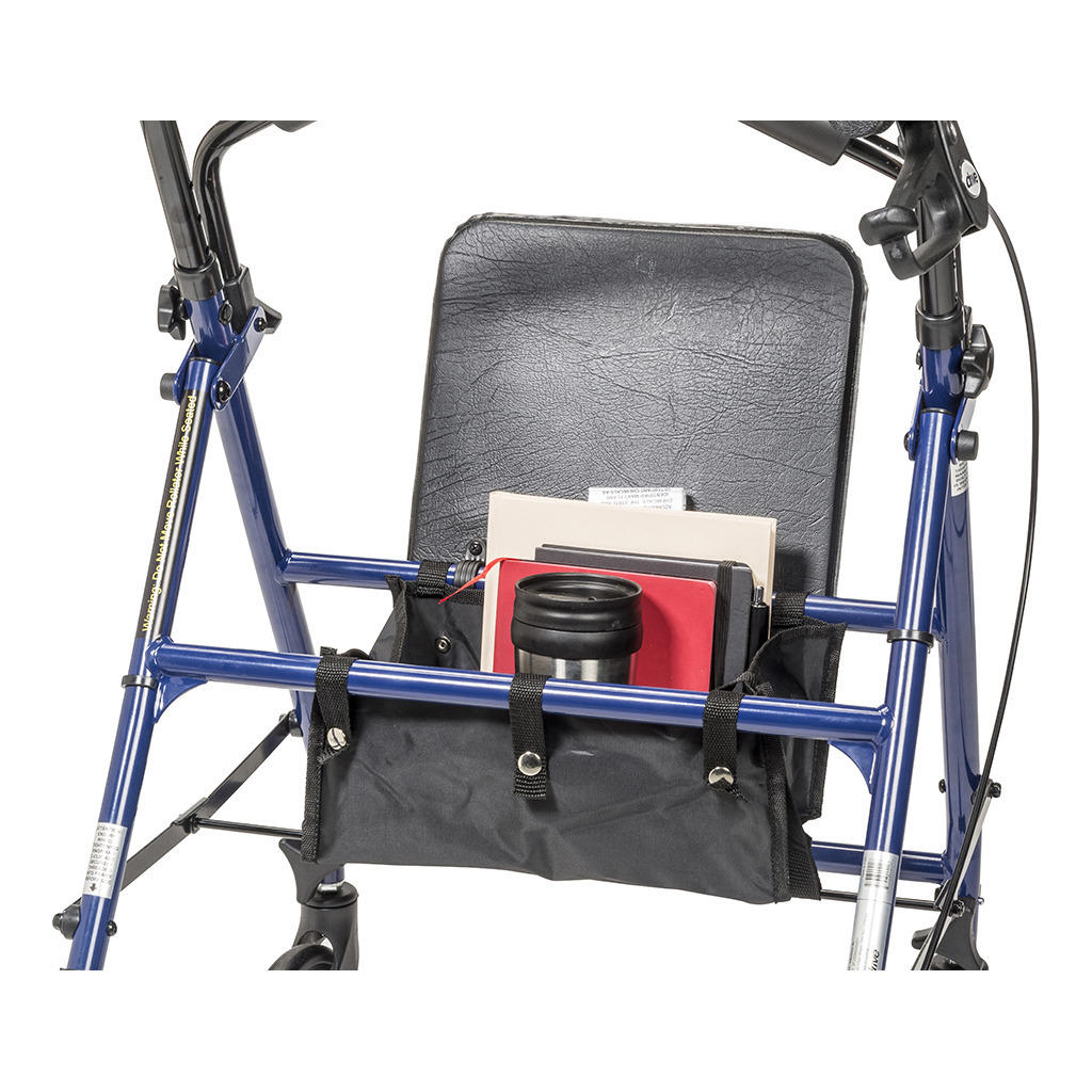 A close-up of the Drive Steel Patient Rollator with 6 wheels shows its black padded seat and a pouch under the seat holding a notebook, folders, and a stainless steel travel mug. The folding rollator’s sturdy frame and side handles from Drive are visible.