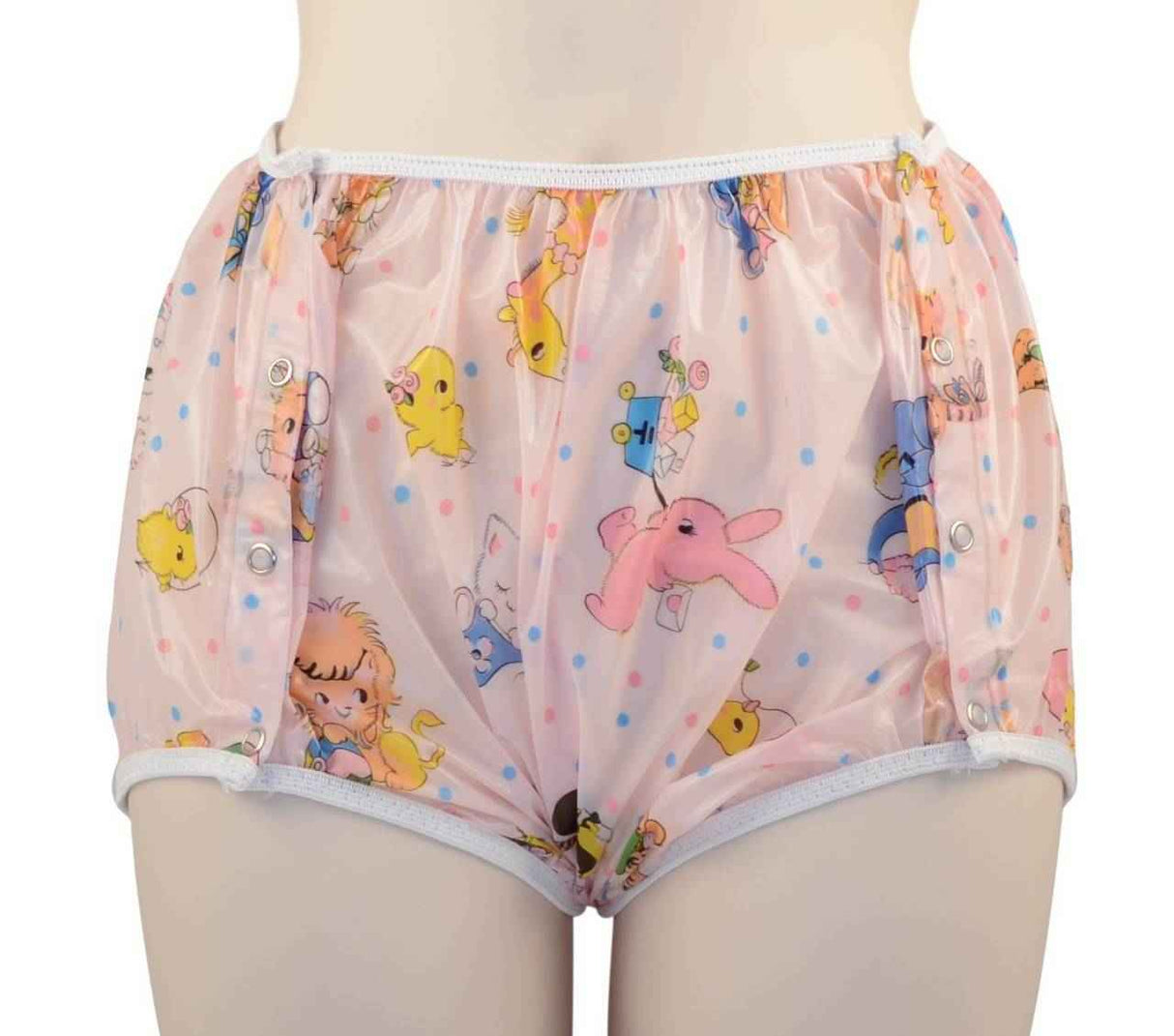 A person wearing Gary Snap-On Plastic Pant - Clearance by Gary in pastel pink, featuring side snaps and decorated with colorful cartoon animals and polka dots.