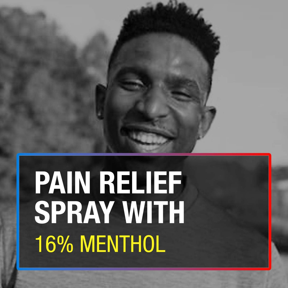 A smiling man stands outdoors in a black-and-white photo. Overlaid text in white and yellow reads: ICY HOT ORIGINAL PAIN RELIEF DRY SPRAY WITH 16% MENTHOL, 4 OZ SPRAY, highlighting topical pain relief and framed by red, blue, and yellow borders.
