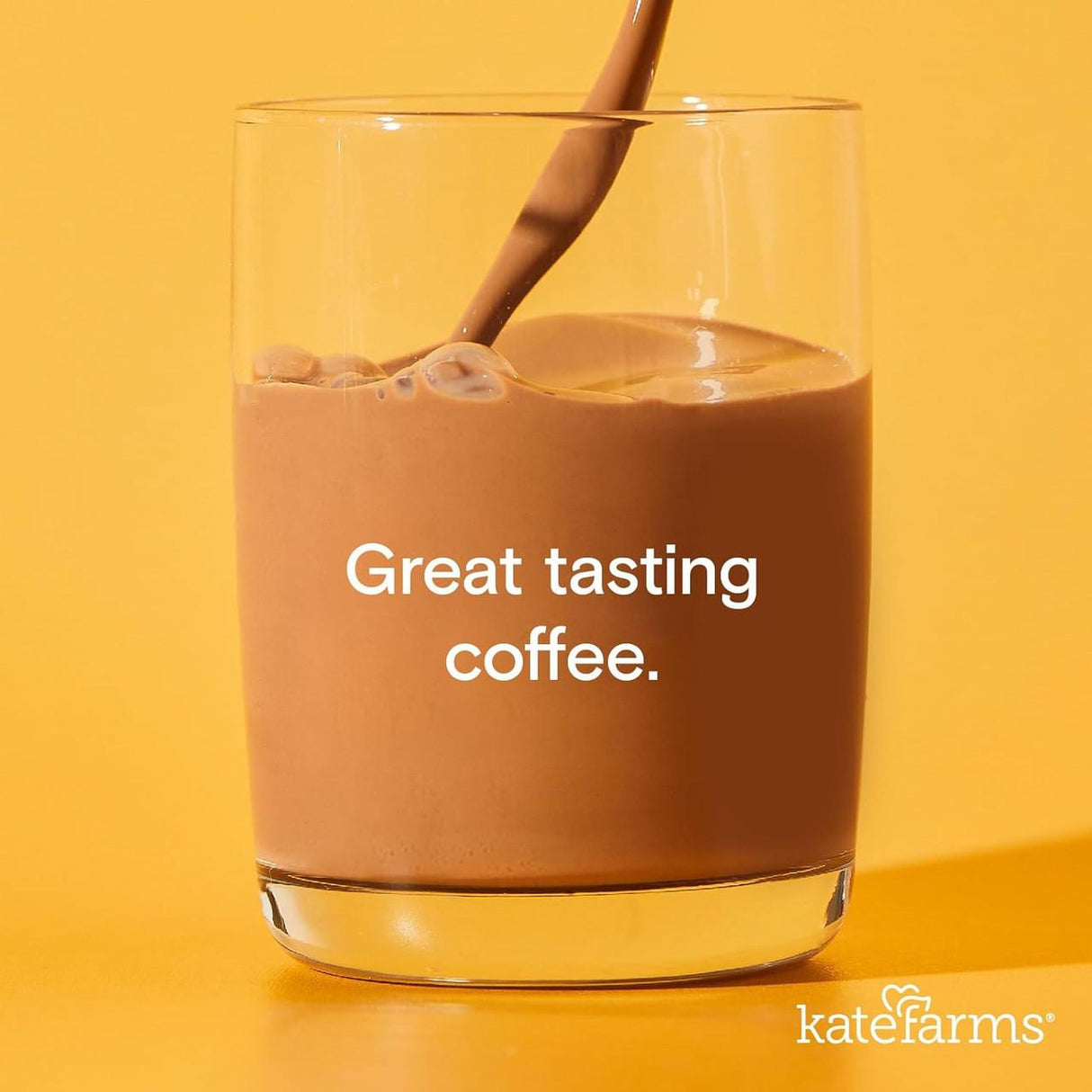 A stream of chocolate-colored Kate Farms Nutrition Shake, Coffee, rich in organic pea protein, pours into a glass against a yellow background, with Great tasting coffee. and the Kate Farms logo at the bottom right.