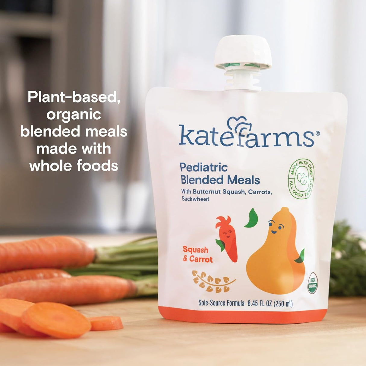 A pouch of Kate Farms Pediatric Blended Meals, Squash & Carrot, CS/12 sits on a counter with sliced carrots and a knife. Text: Plant-based nutrition for tube feeding or pediatric meals made with whole foods from Kate Farms.