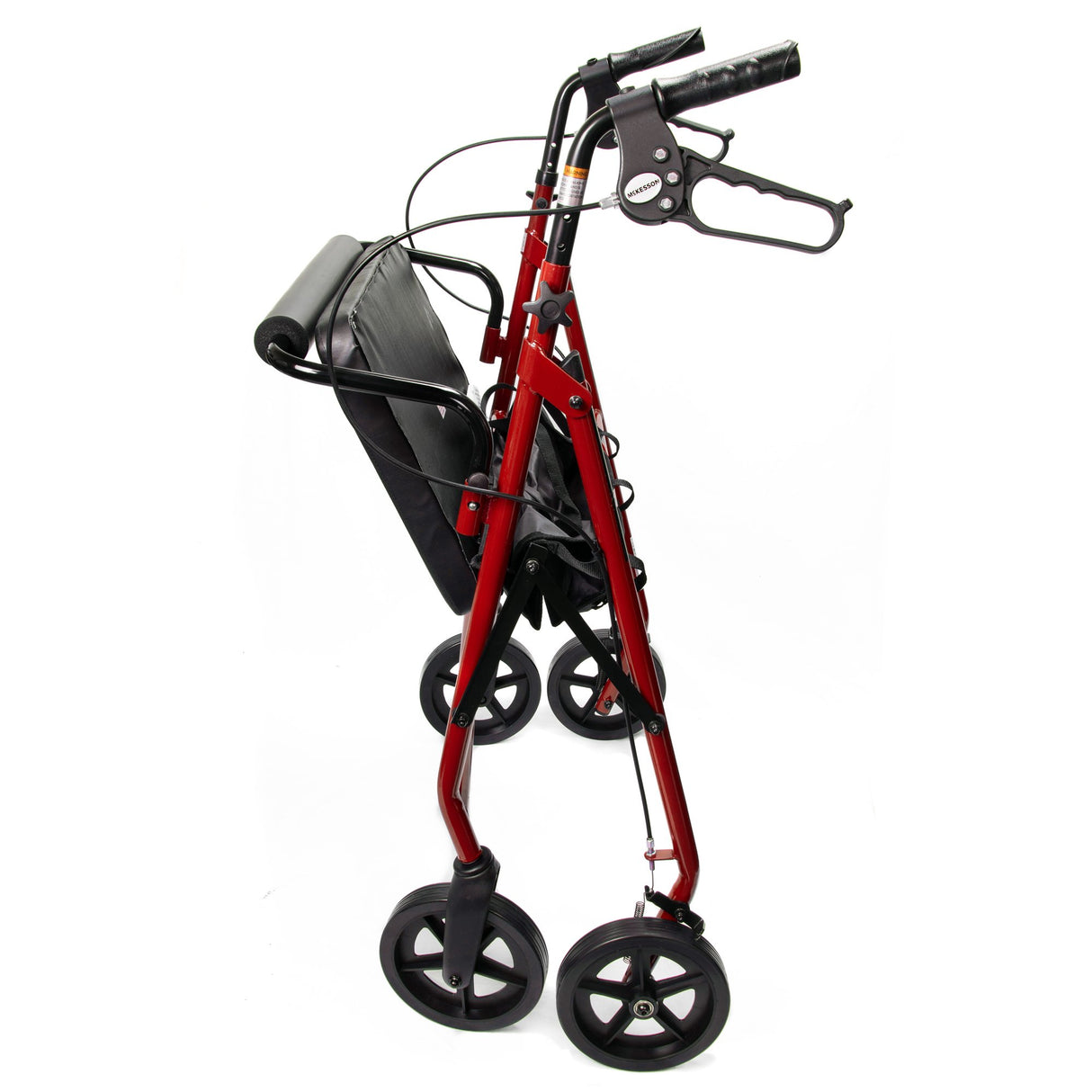 The McKesson Bariatric 4 Wheel Folding Heavy Duty Steel Rollator, shown from the side against a white background, features a red frame, black adjustable handles, built-in seat, four wheels, and storage pouch.