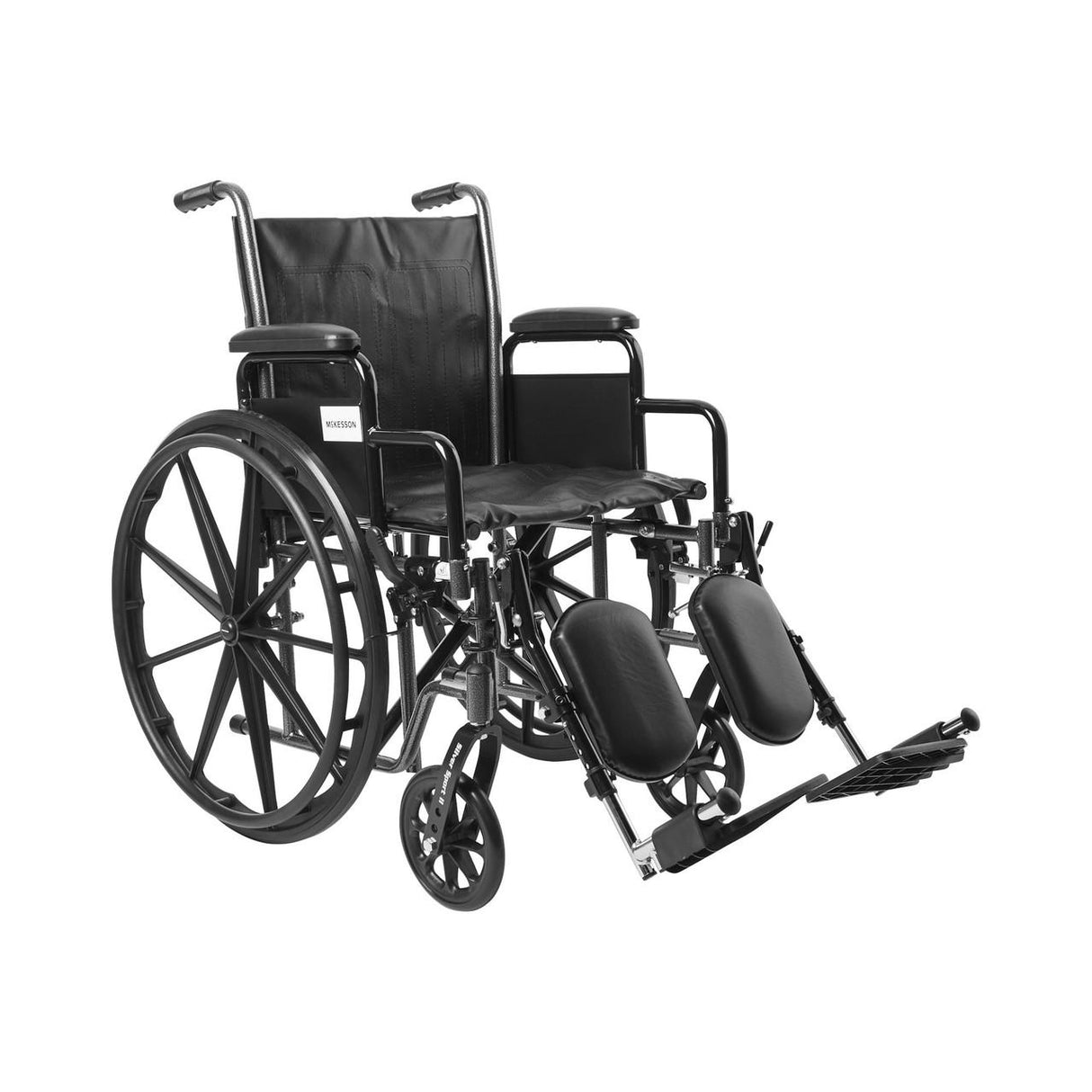 The McKesson Standard 18 Wheelchair features elevating swing away footrests and detachable desk arms, large rear wheels, and small front wheels. Photographed against a white background. Brand: McKesson.