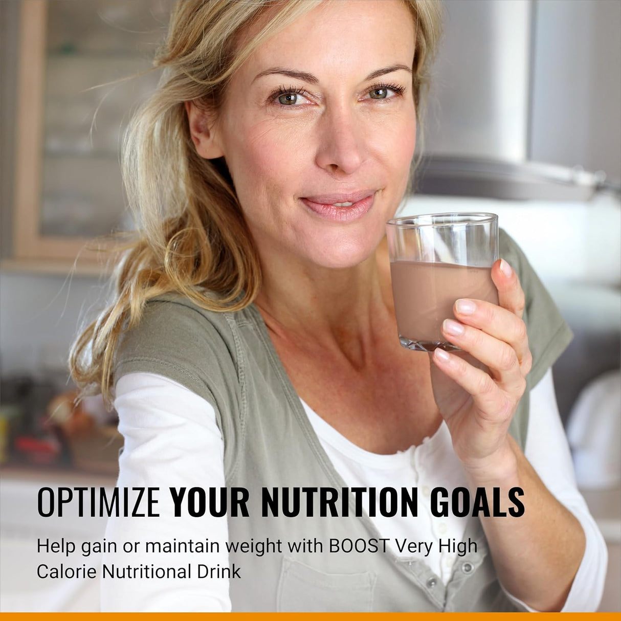 A smiling blonde woman holds a Nestle Boost Very High Calorie (VHC) Chocolate 8 oz drink in a kitchen. Text: Achieve your nutrition goals and support weight gain or maintenance with this high-calorie protein drink from Nestle Nutrition.
