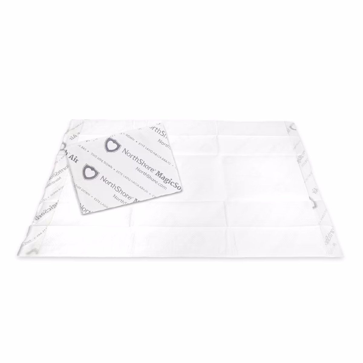 The NorthShore MagicSorb Air Super-Absorbent Disposable Underpad is large, white, air-permeable, with patterned edges and a smooth surface. It features a rectangular absorbent sheet for maximum absorbency.