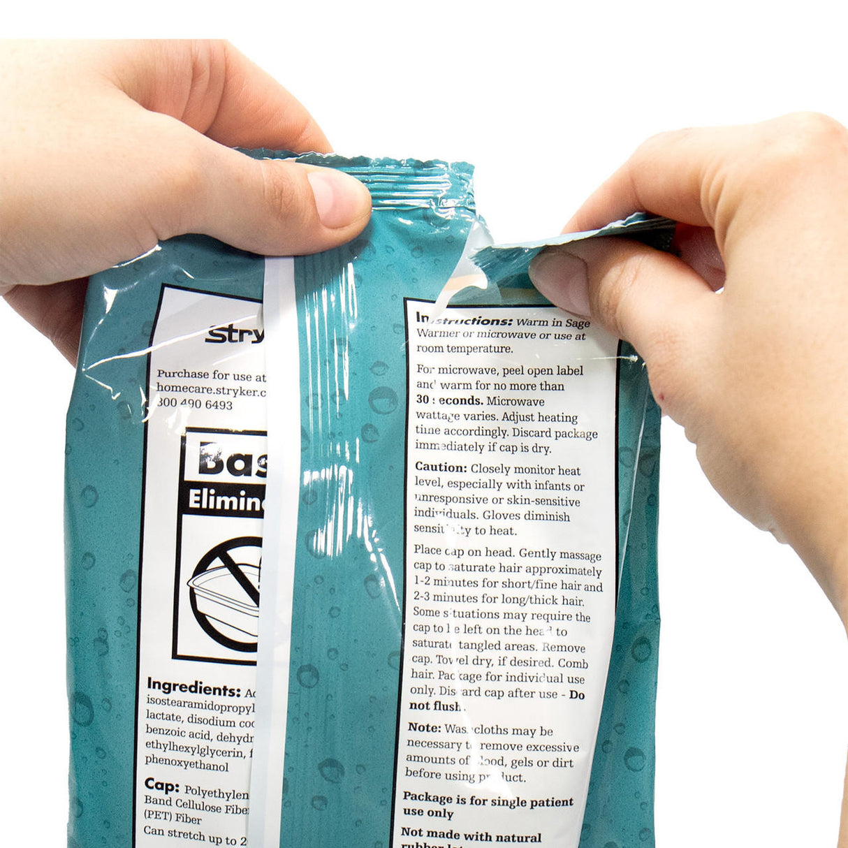 Close-up of two hands opening a teal Stryker Sage Rinse-Free Shampoo Cap package by Sage Products, showing white label and printed instructions on front—ideal for hair care when mobility is limited.