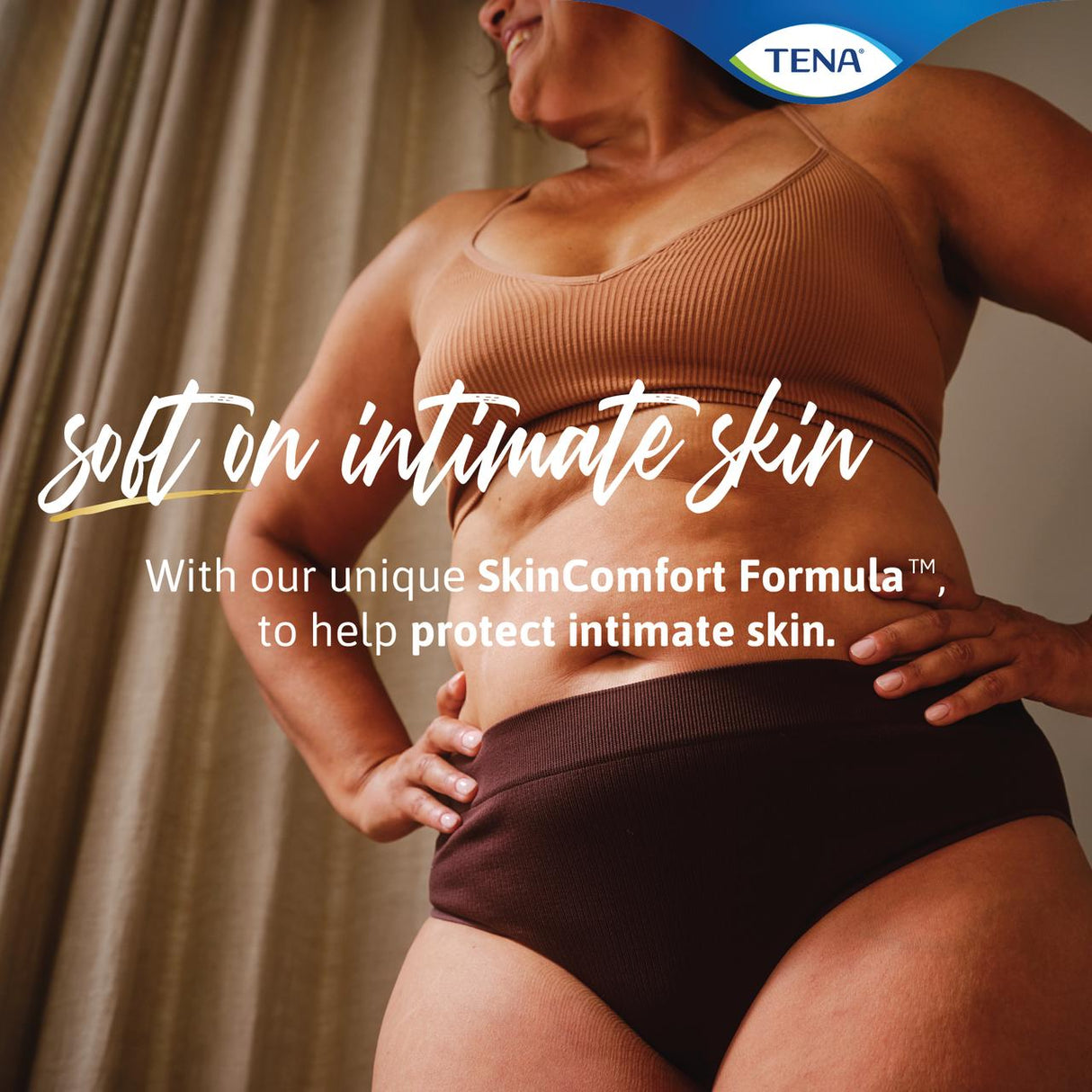 A woman in a beige bra and dark underwear stands with hands on hips, smiling confidently. Text reads: Soft on intimate skin. With our unique SkinComfort Formula™ for post-partum incontinence. TENA Sensitive Care Extra Coverage Maximum Long Pads logo at top.