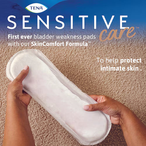A person holds a TENA Sensitive Care Incontinence Pad, Ultimate. The TENA packaging highlights its SkinComfort Formula and claims effective bladder leakage protection. The pad is white, rectangular, and has soft, rounded edges.