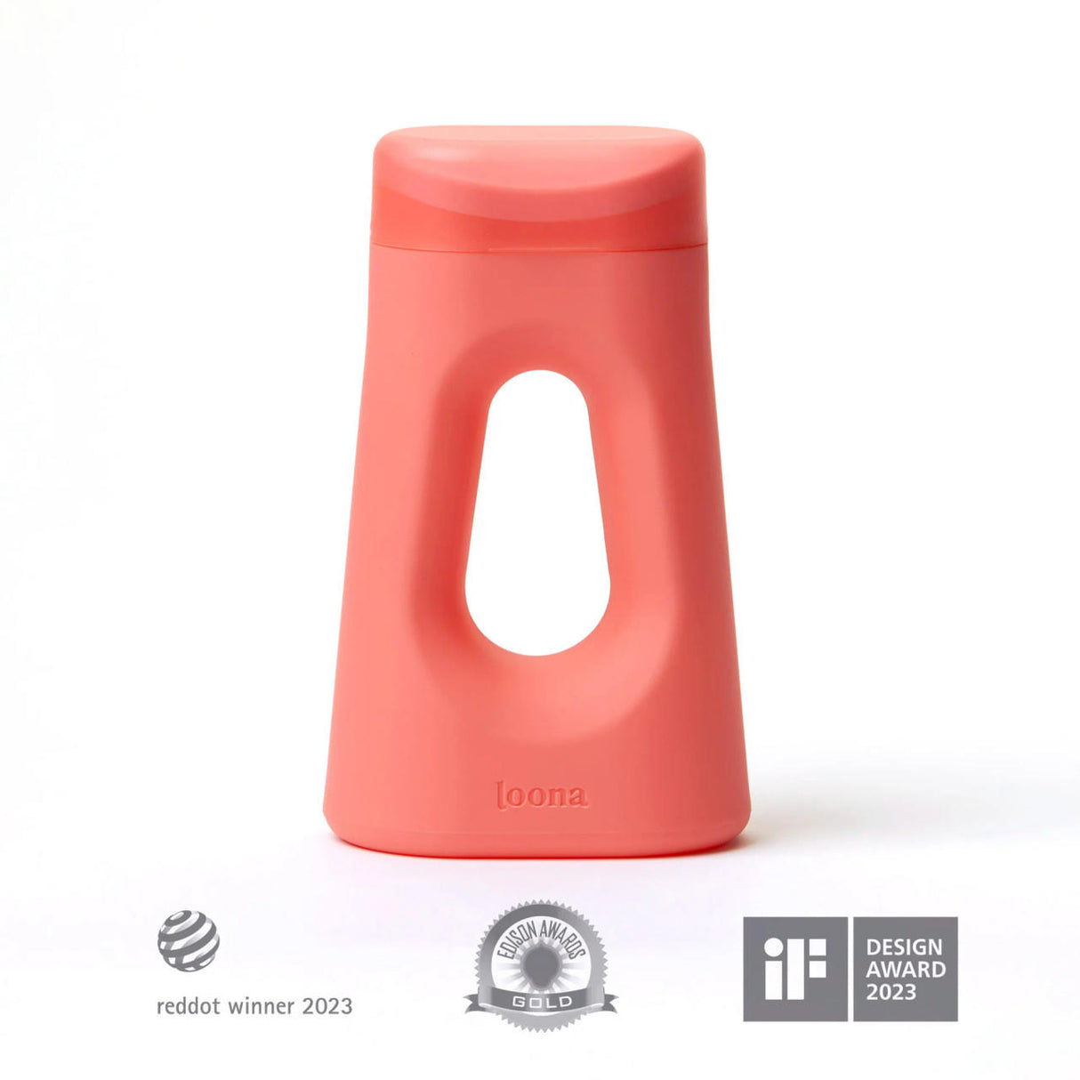 The Loona Female Urinal With Closure by Boom Home Medical is a modern coral travel urinal with a unique triangular shape, large center cutout, and loona embossed. Features Red Dot Winner 2023, Good Design Award, and iF Design Award 2023 logos below.