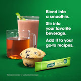 A pink smoothie, tea, a blueberry muffin, and a Benefiber Prebiotic Fiber Supplement packet by Benefiber sit on a green background. Text suggests adding unflavored Benefiber to smoothies, drinks, and recipes for digestive health.